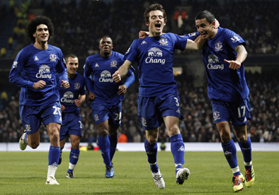 Leighton Baines celebrates with Tim Cahill Everton